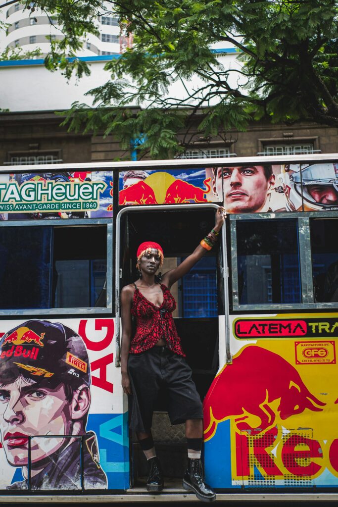 Vibrant street scene in Nairobi featuring a stylish person by a colorful matatu.